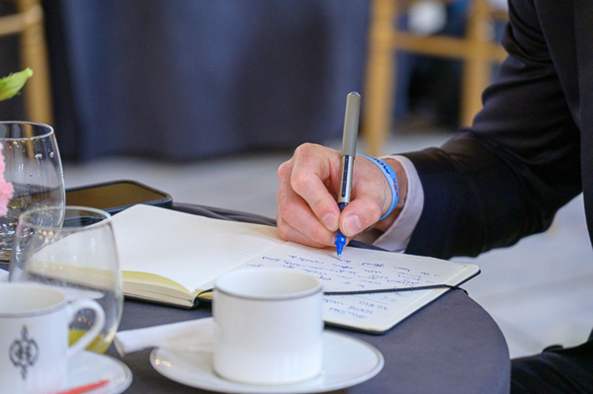 Executive taking notes during conference